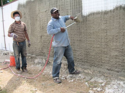 2 men spraying M2 with cement