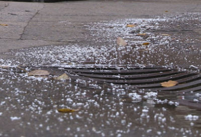 styrafoam bits flowing into a drainage culvert