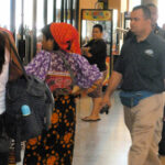 Native Indian in traditional garb and others at Albrook bus station in Panama City, Panama