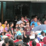 A diverse group of people waiting for a parade in Panama