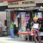 Men hanging out by make shift stores