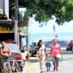 women and child walking in Puerto Armuelles, Panama