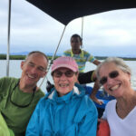 3 people and boatman in an open air boat