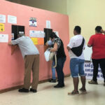 5 people waiting to pay traffic tickets in David, Panama